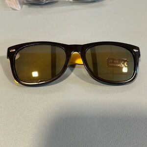 Yellow, baby Ray-Ban type sunglasses with yellow reflection in the lens